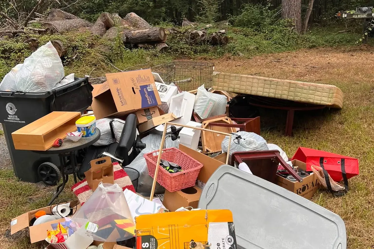 Boxes, bins and household junk piled on a lawn before pickup