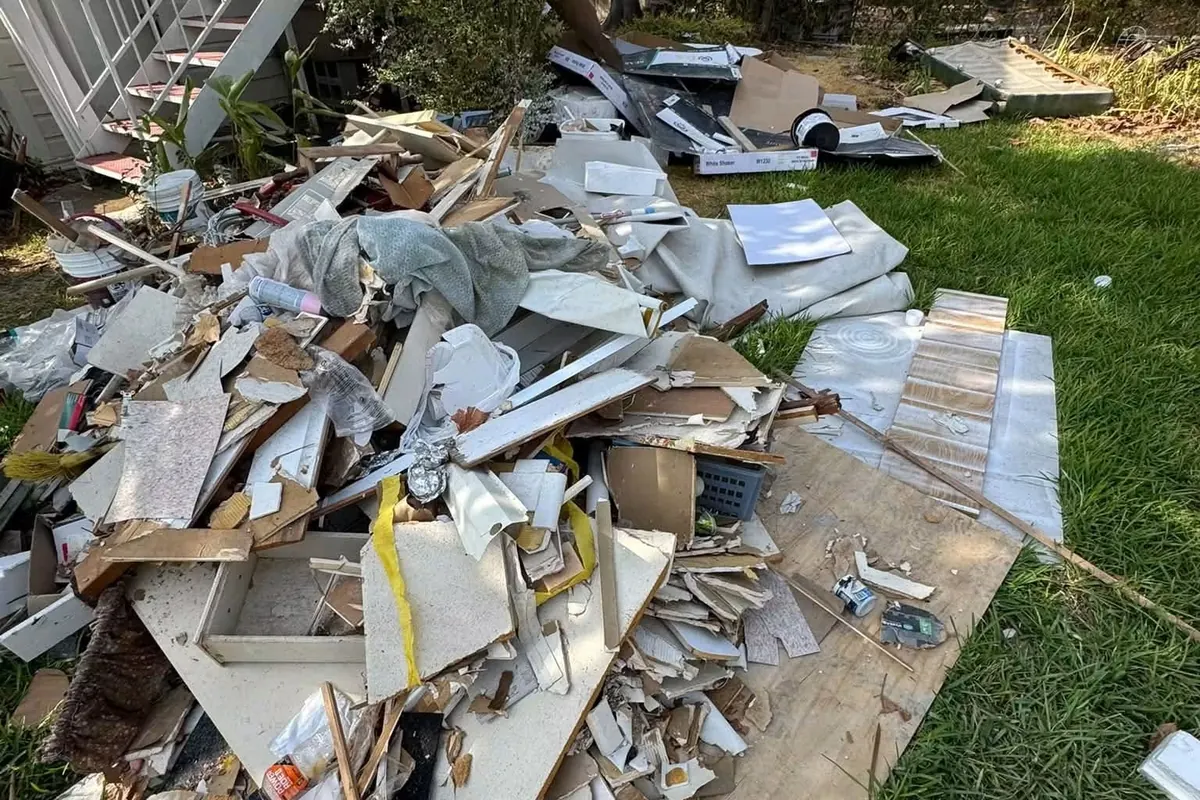 Drywall, trim and renovation debris piled on a lawn